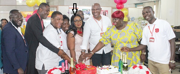 Kate Baaba Hudson (arrowed), immediate past Editor of the Junior Graphic, being assisted by some members of the Editorial Board to cut her 60th birthday cake during her send-off party at the newsroom of the GCGL head office in Accra. Among them are Ato Afful (3rd from right), MD, Franklin Sowa (2nd from left), Director Marketing and Sales, and Kobby Asmah (3rd from left), Editor, the Daily Graphic